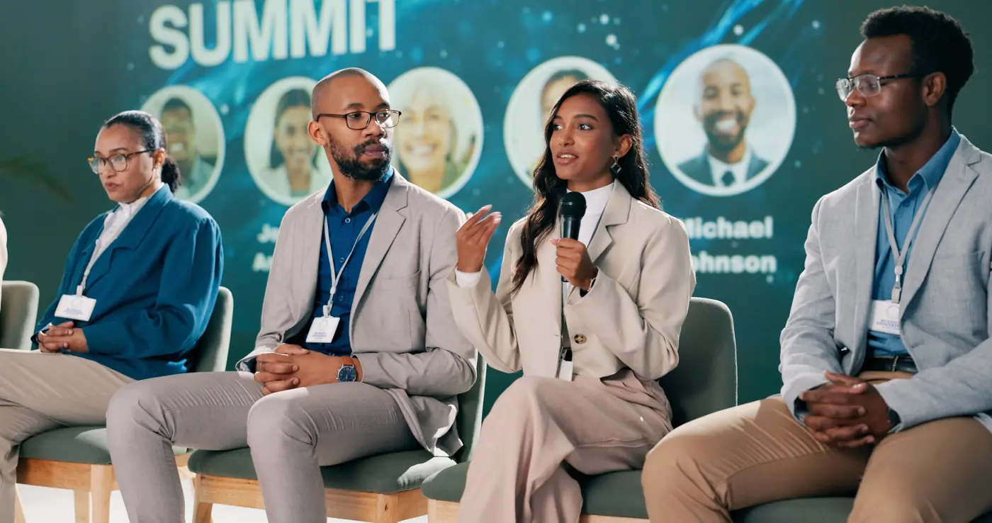 Panel discussion on stage at a business summit