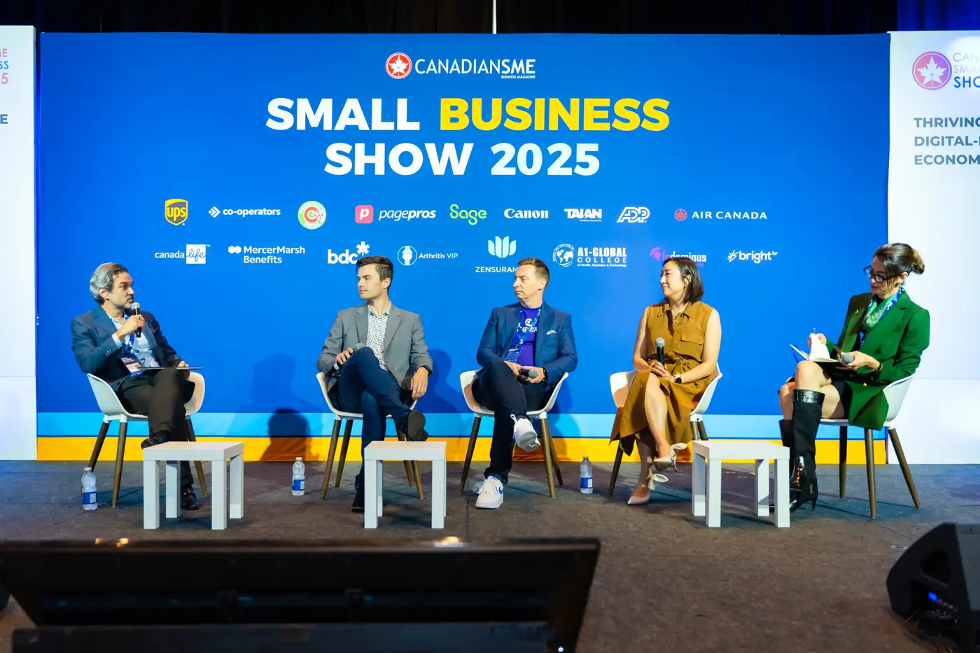 Five-person panel discussion on stage