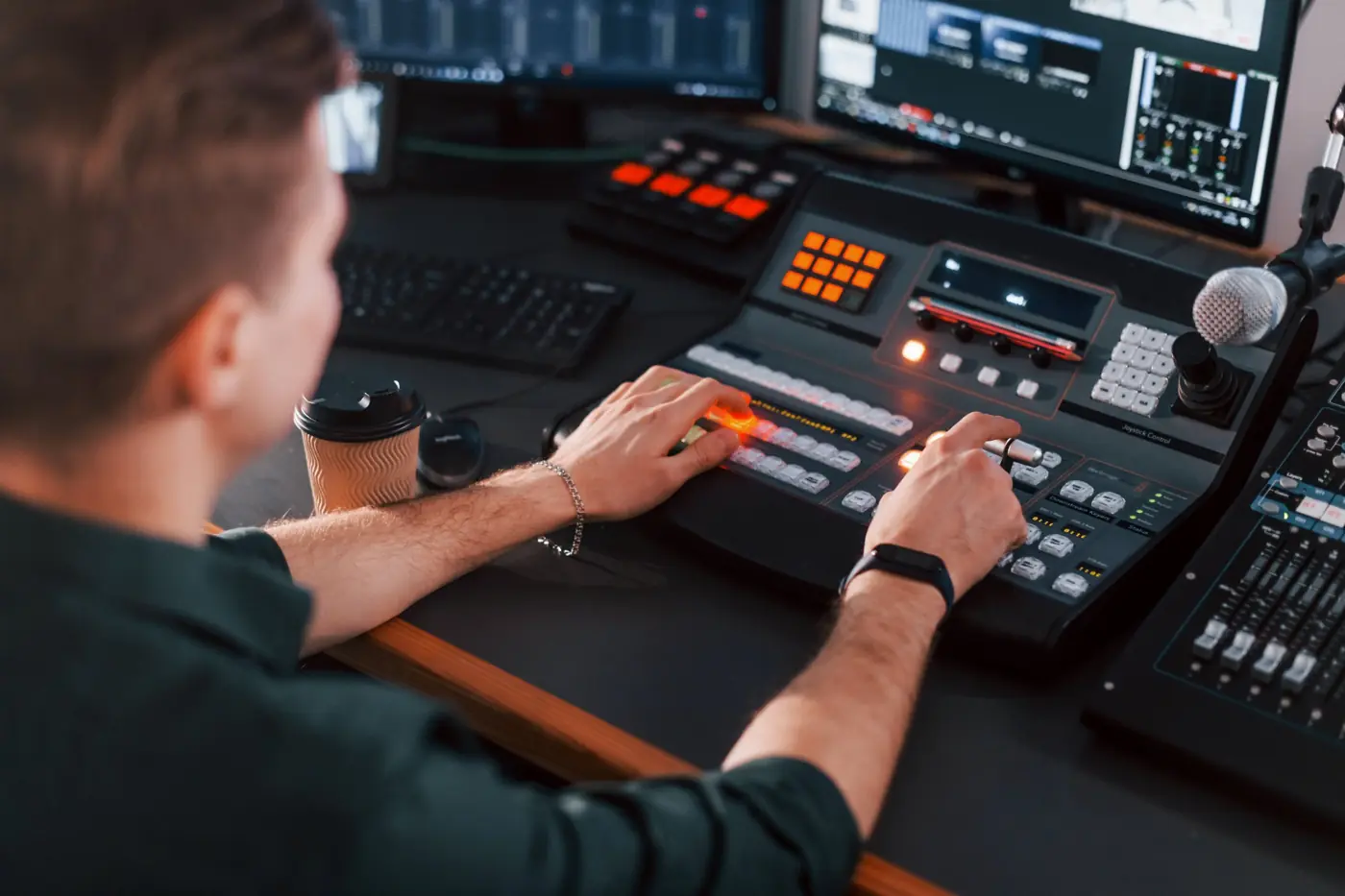 Operator using a live video production switcher